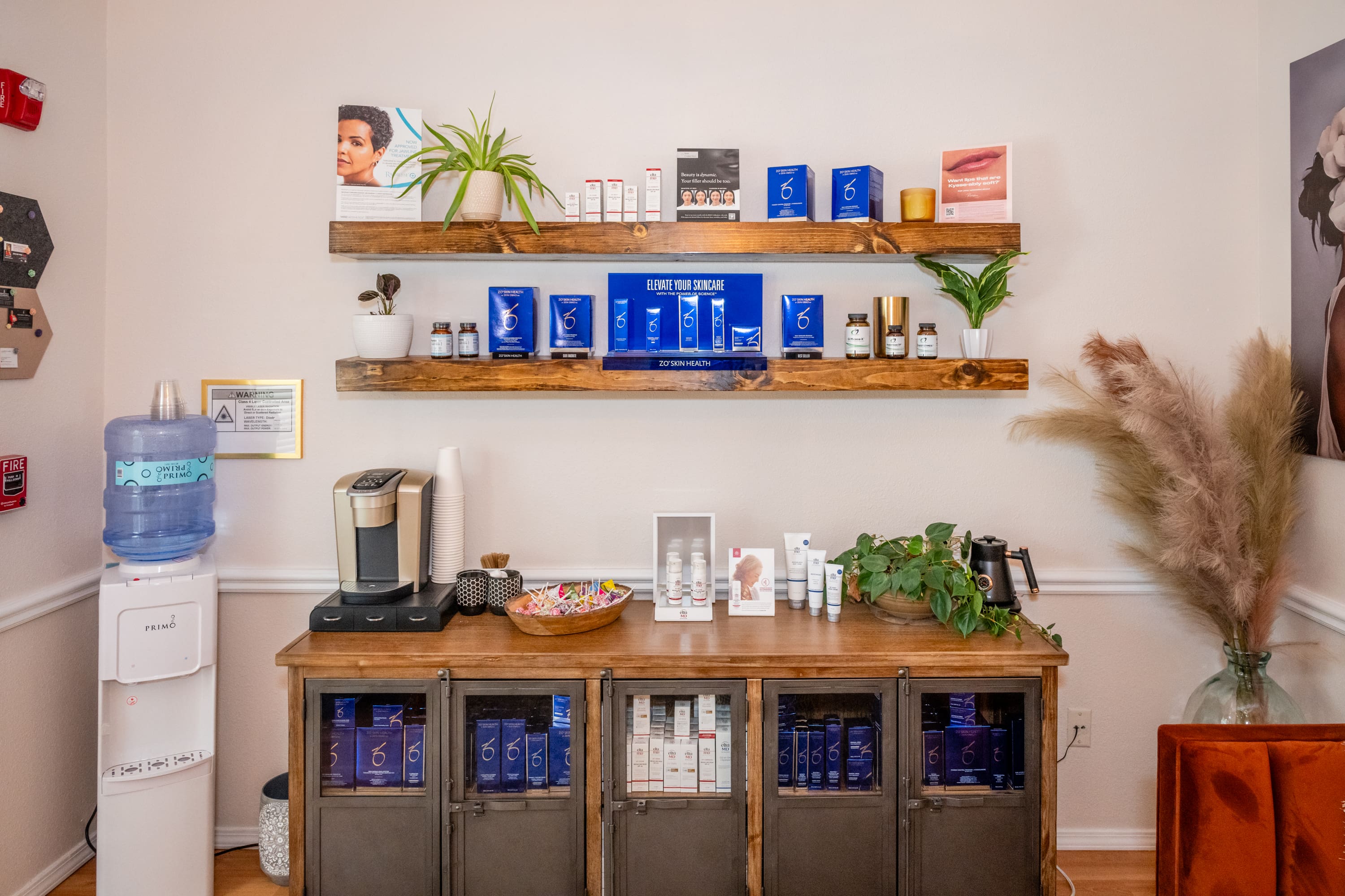 A coffee bar with blue cups and glasses on the shelves.