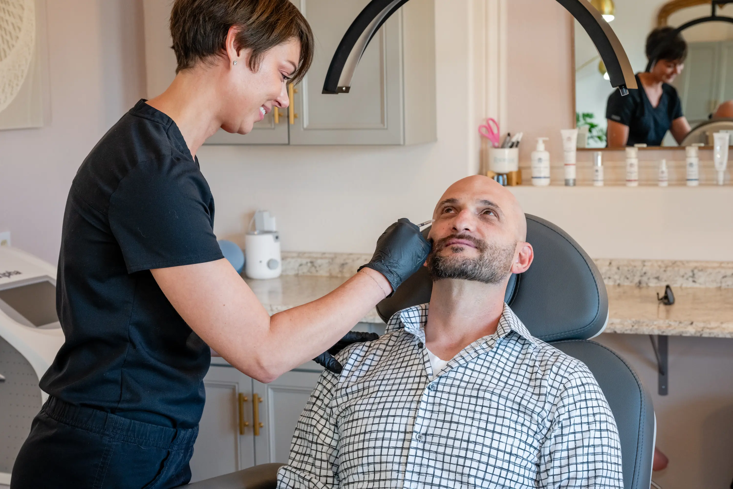 Man receiving facial treatment at clinic.