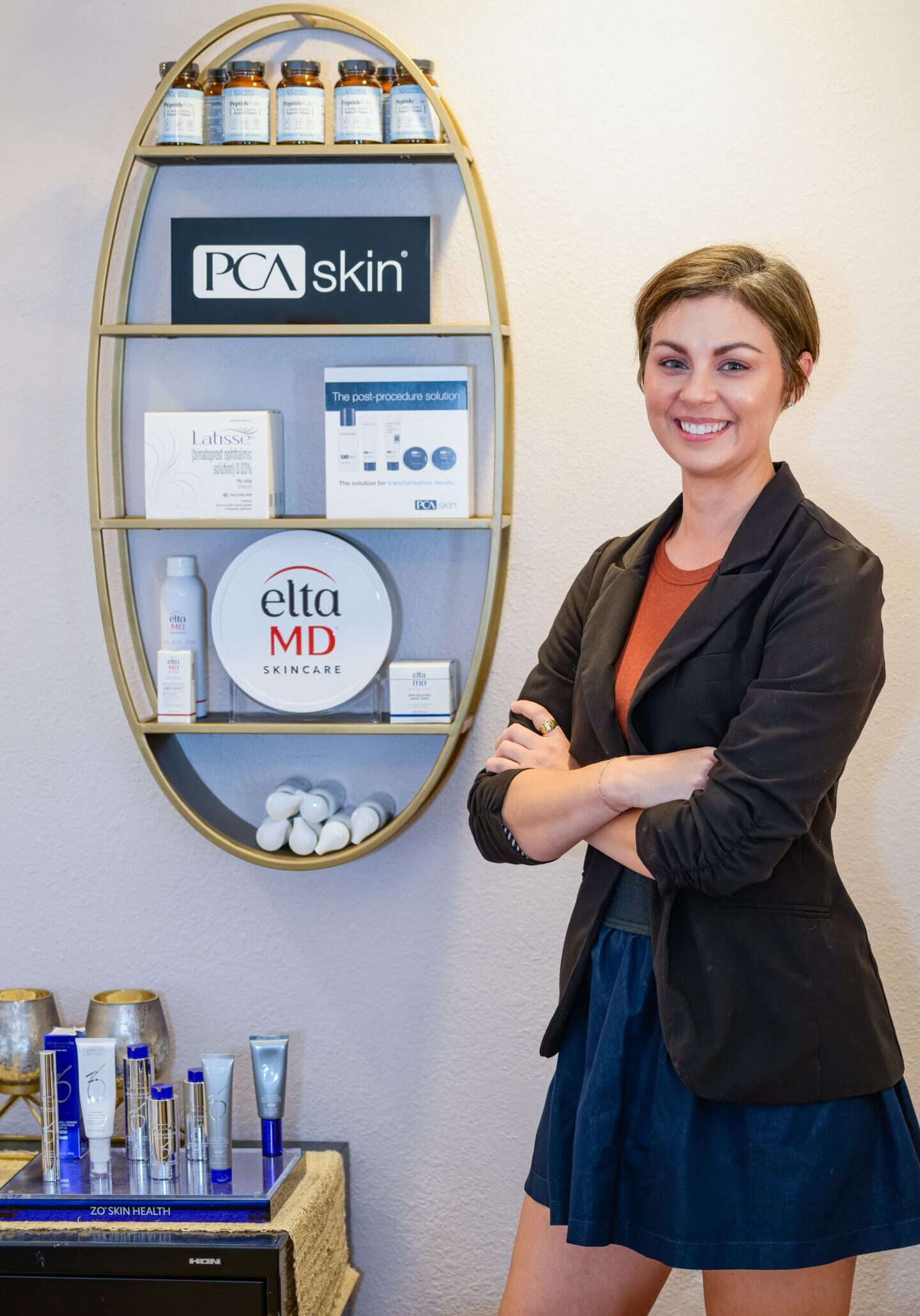 A woman standing in front of some products.